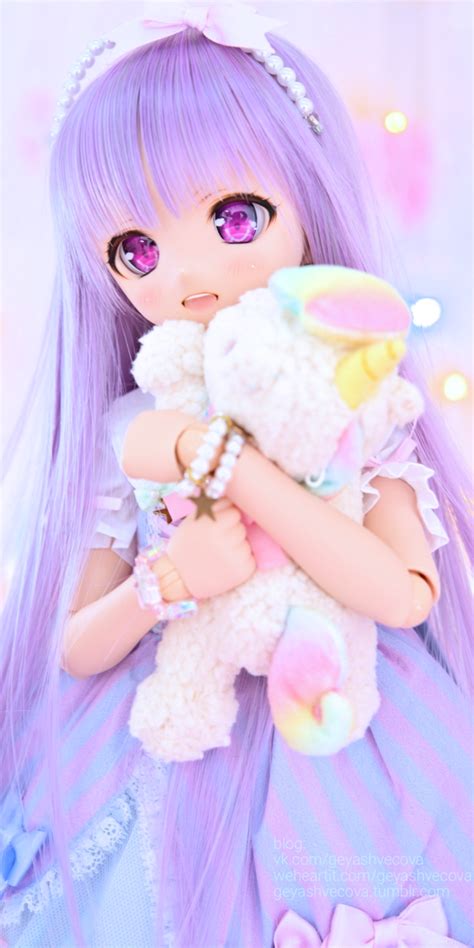 A Doll With Purple Hair Holding A Stuffed Animal