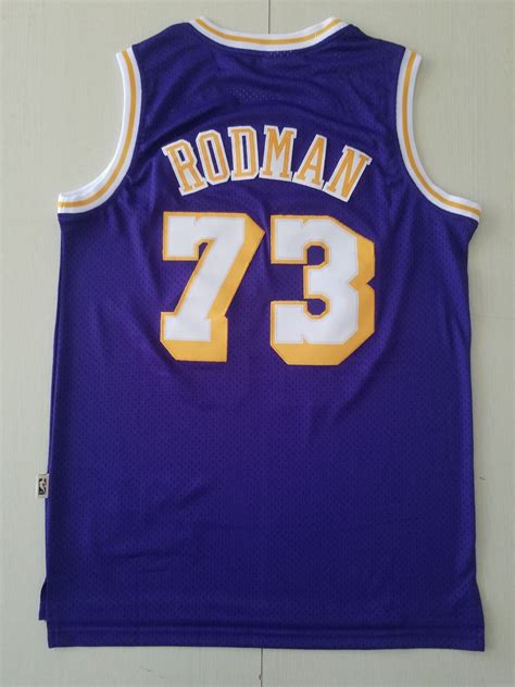 A Purple Jersey With The Number 73 On It Is Hanging Up Against A White Wall