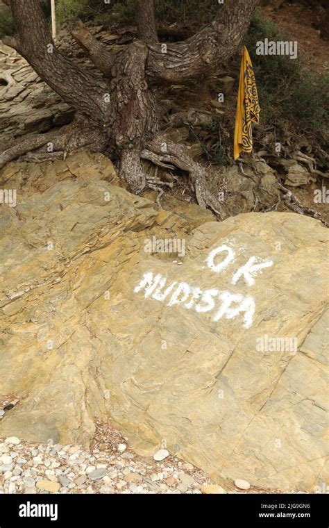 Ok Nudist Written In White On A Stone Of A Beach In Spain Stock Photo