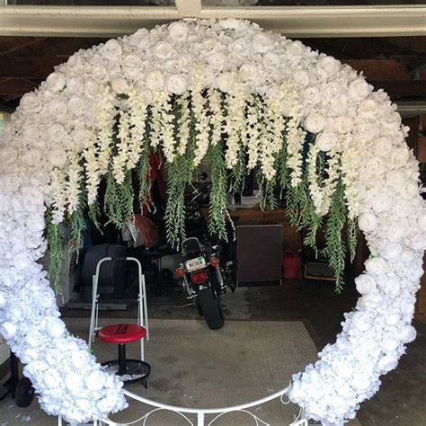 A White Flower Covered Archway In A Garage