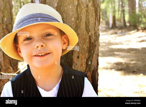 Portrait Of Boy Wearing Straw Hat In Park Stock Photo Alamy