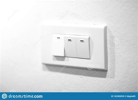 A Light Switch A Plastic Mechanical Switch Of White Color Installed On