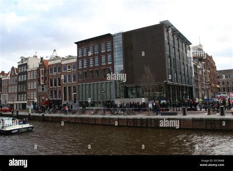 People Standing In Line In Front Of The Anne Frank House Museum