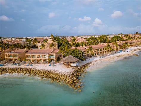 Aruba Caribbean White Beach With Palm Trees And Luxury Swimming Pool
