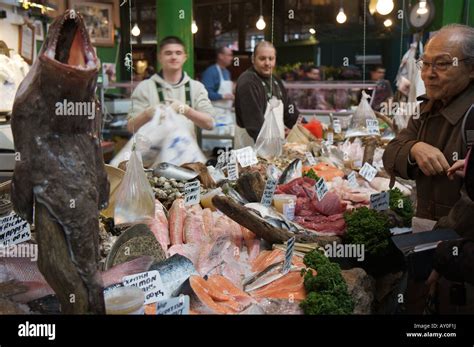 A Customer Looking At A Large Fish For Sale At A Fishmongers In London