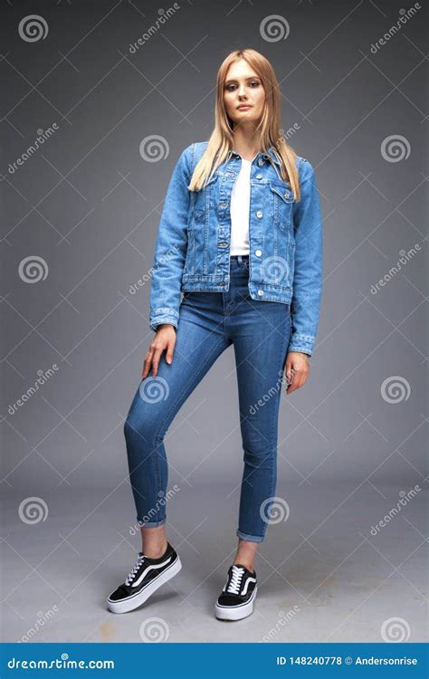 Beautiful Blonde Woman Dressed In A Denim Jacket And Blue Jeans Stock Photo Image Of Blonde