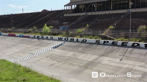 Overflightstock Abandoned Pit Row And Empty Racetrack Grandstand