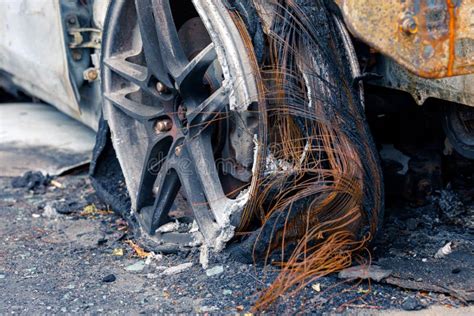 Wheel Of Burned Car Burnt Flat Tire On The Car Is On The Gray Asphalt
