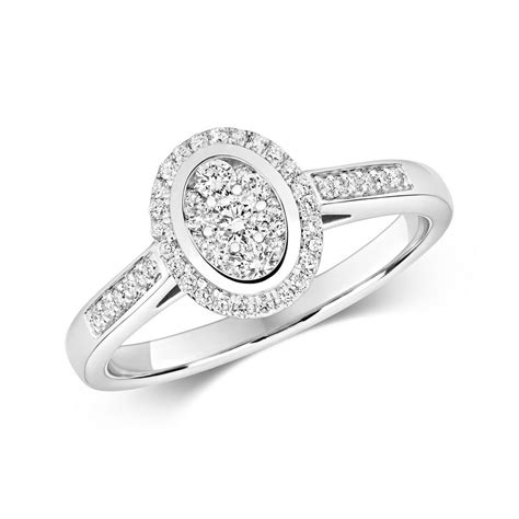 Pop the question with one of our stunning diamond engagement rings. Oval Shaped Diamond Cluster Ring with Diamond Shoulders in ...