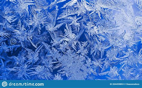 Ice Crystals Close Up On A Window Glass In Winter Dark Blue And White