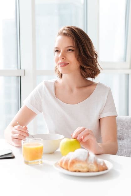 Free Photo Amazing Woman Sitting Indoors At The Table With Juice