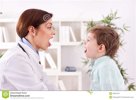 Examination Of The Throat Mouth And Child By A Doctor The Boy Opened