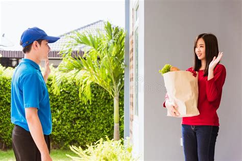 Delivery Man Making Grocery Service Giving Fresh Vegetables In Paper