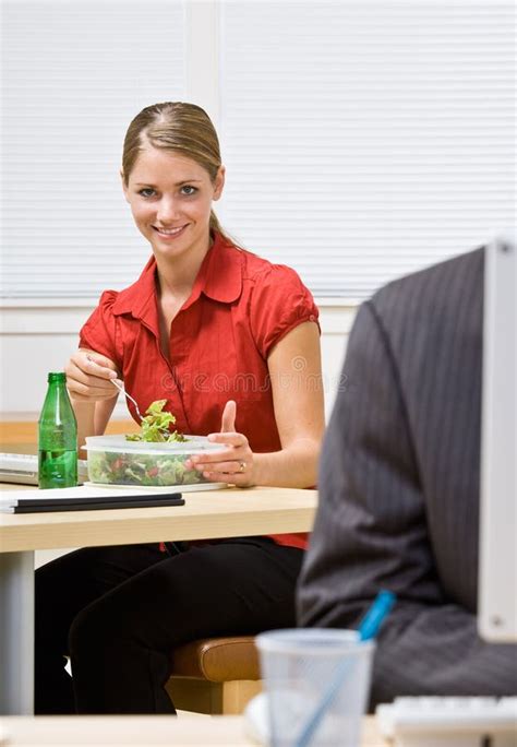 Businesswoman In Cubicle With Laptop Eating Salad Stock Photo Image