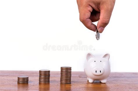 Hand Putting Coin To Piggy Bank With Stack Coin Saving Money And