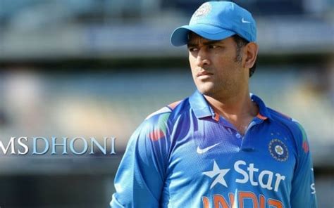 Ms Dhoni Is Wearing Blue Sports Dress And Cap Standing In Blur