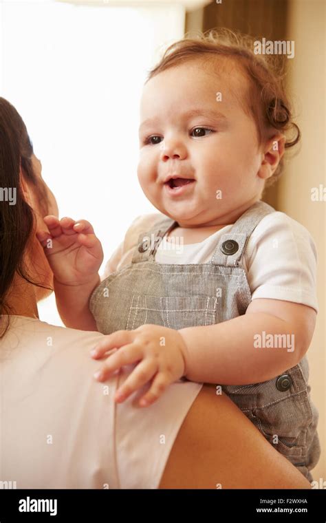 Mother Cuddling Happy Baby Boy At Home Stock Photo Alamy
