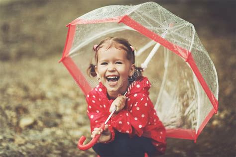 Happy Child Girl Laughing With An Umbrella In Rain Stock Image Image