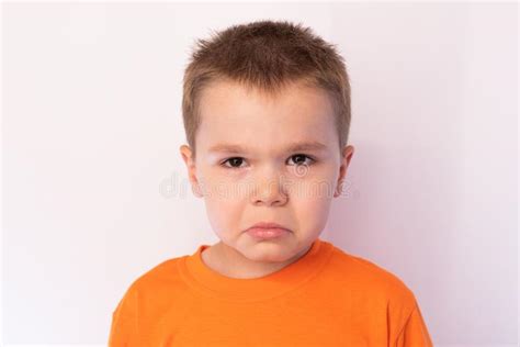 Cute Little Boy With Sad Face Against A Bright Background