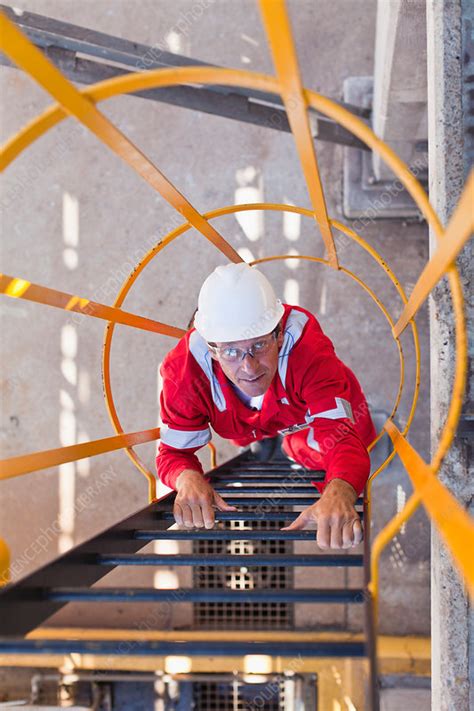 Worker Climbing Ladder At Oil Refinery Stock Image F0053771