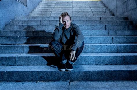 Depressed Sad Young Man Crying Sitting On Stairs Feeling Miserable