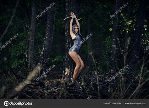 A Girl Tied To A Tree In A Forest Dark Forest Esoterics Stock Photo By MaksymBondarenko