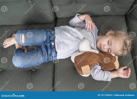 Child Sleeping On The Couch In Clothes Stock Photo Image Of Baby