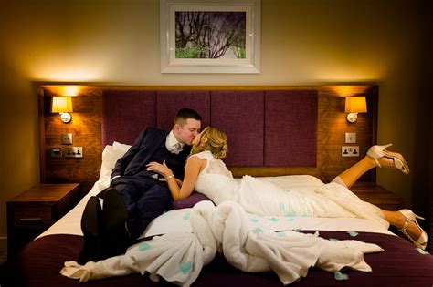 A Newly Married Couple Kissing In Their Bedroom Suite Wedding Night