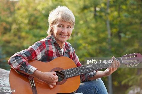 Mature Woman Playing Guitar Photos And Premium High Res Pictures