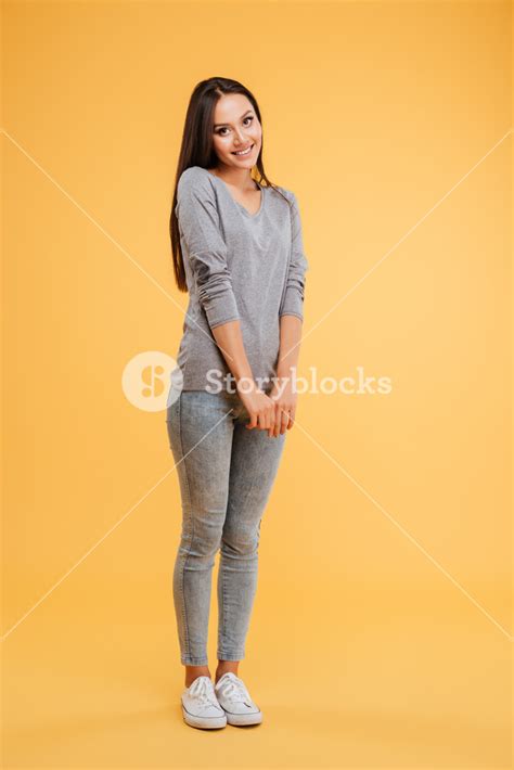 Full Length Shy Woman In Studio Isolated Orange Background Royalty
