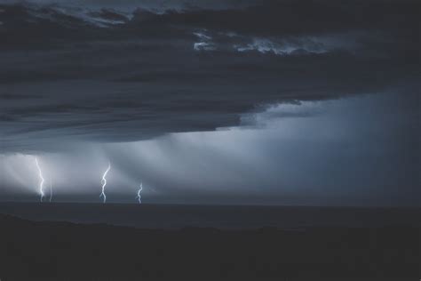 Thunderstorm With Glimmering Lightnings Over Ocean · Free Stock Photo