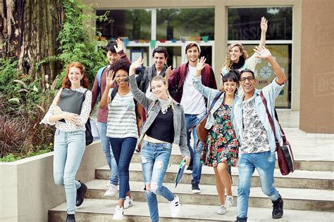 College Students Waving While Walking On Campus Stock Photo Dissolve