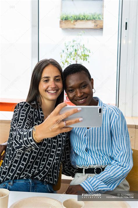 Cheerful Multiracial Female Colleagues Taking Self Portrait On