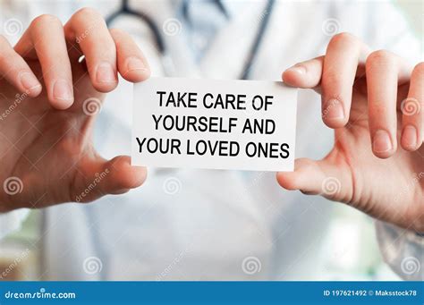 Doctor Holding A Card With Text Take Care Of Yourself And Your Loved