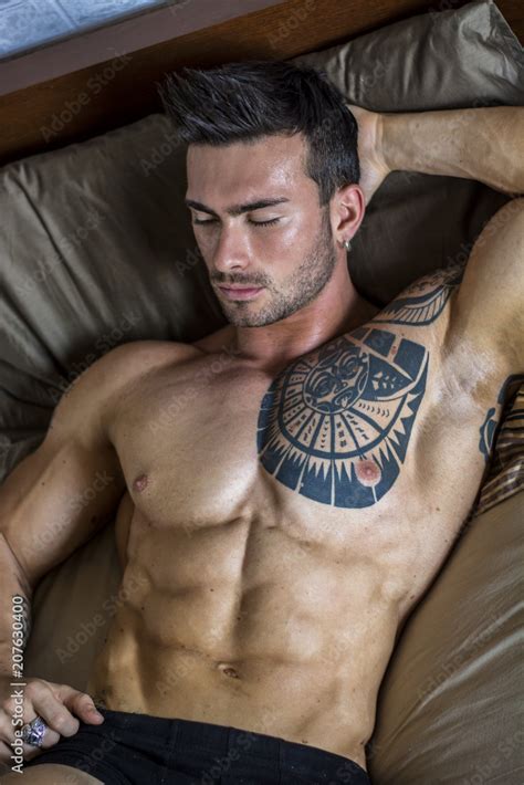 Shirtless Muscular Sexy Male Model Lying Alone On Bed In His Bedroom Relaxing With Eyes Closed