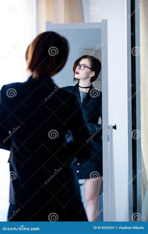 Beautiful Young Woman Standing In Front Of Mirror And Looking At Stock Image Image Of Indoors