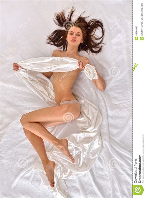 Beautiful Naked Woman In Panties On White Bed Stock Image