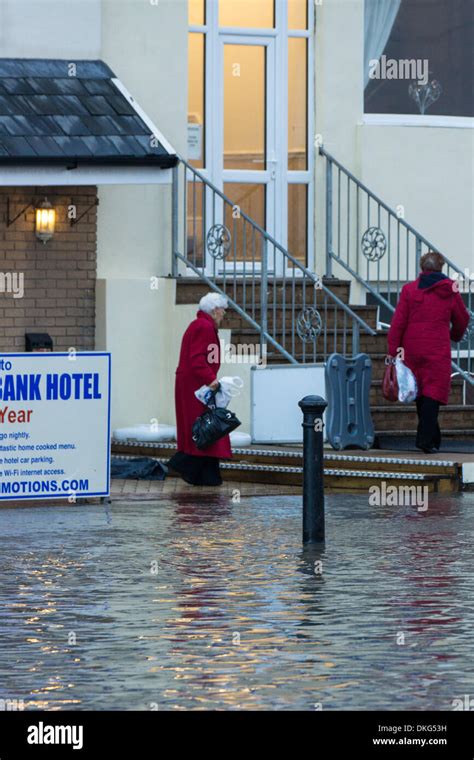 Residents From A Seafront Hotel Try To Stay Dry From The Flooded