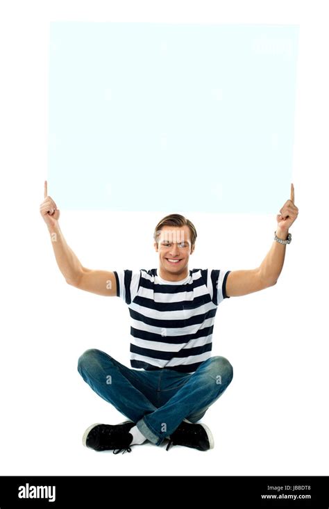 Seated Man Showing Blank Signboard Against White Background Stock Photo Alamy