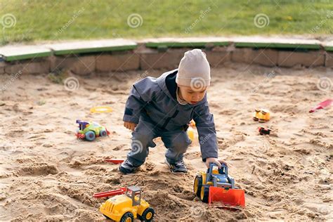 Child Playing With Toys In Sandbox Little Boy Having Fun On Playground