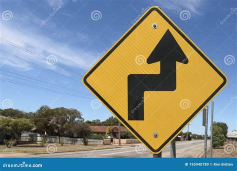 Black And Yellow Road Sign Warning Of Sharp Turn To The Right Then