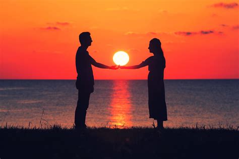 Two People Holding Hands At Sunset 1864712 Stock Photo At Vecteezy