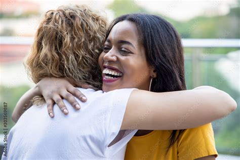 African Black Woman Hugging Caucasian White Woman Friend Concept Of
