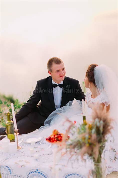 The Newlywed Couple Is Enjoying The Wedding Picnic Near The Sea Stock