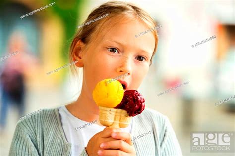 Cute Little Girl Eating Ice Cream Outdoors Stock Photo Picture And
