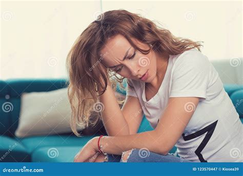 Mom And Son Are Sitting On Couch With Closed Eyes And Foreheads Leaning Against Each Other