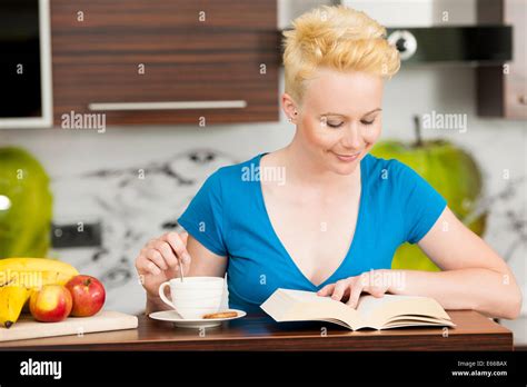 Beautiful Young Caucasian Blonde Woman Drinking Coffee In The Kitchen