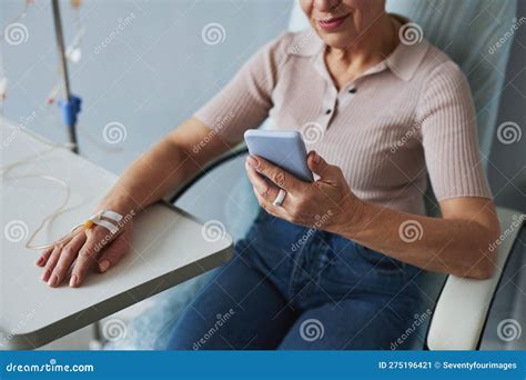Minimal Closeup Of Mature Woman Using Smartphone During Iv Drip