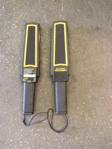 Two Black And Yellow Electric Tools Laying On The Ground Next To Each