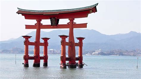 Red Torii Gate At The Itsukushima Shrine During High Water Miyajima